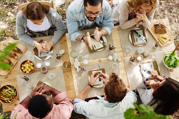 Group of young friends gathered at Thanksgiving dinner table